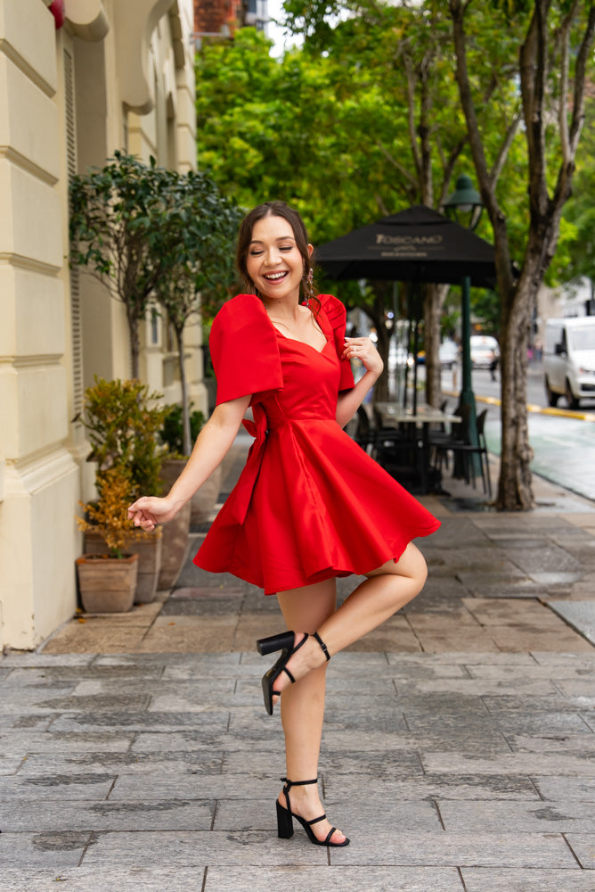 Mestiza Filipiniana woman wearing duchess satin red Filipiniana dress with a-line skirt and filipiniana sleeves
