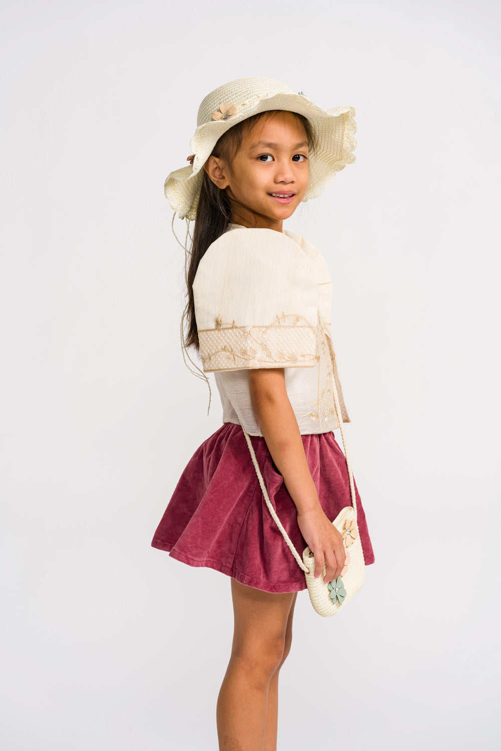 Side view of Aiza children's Filipiniana bolero in cream jusilyn with butterfly sleeves and embroidered detailing