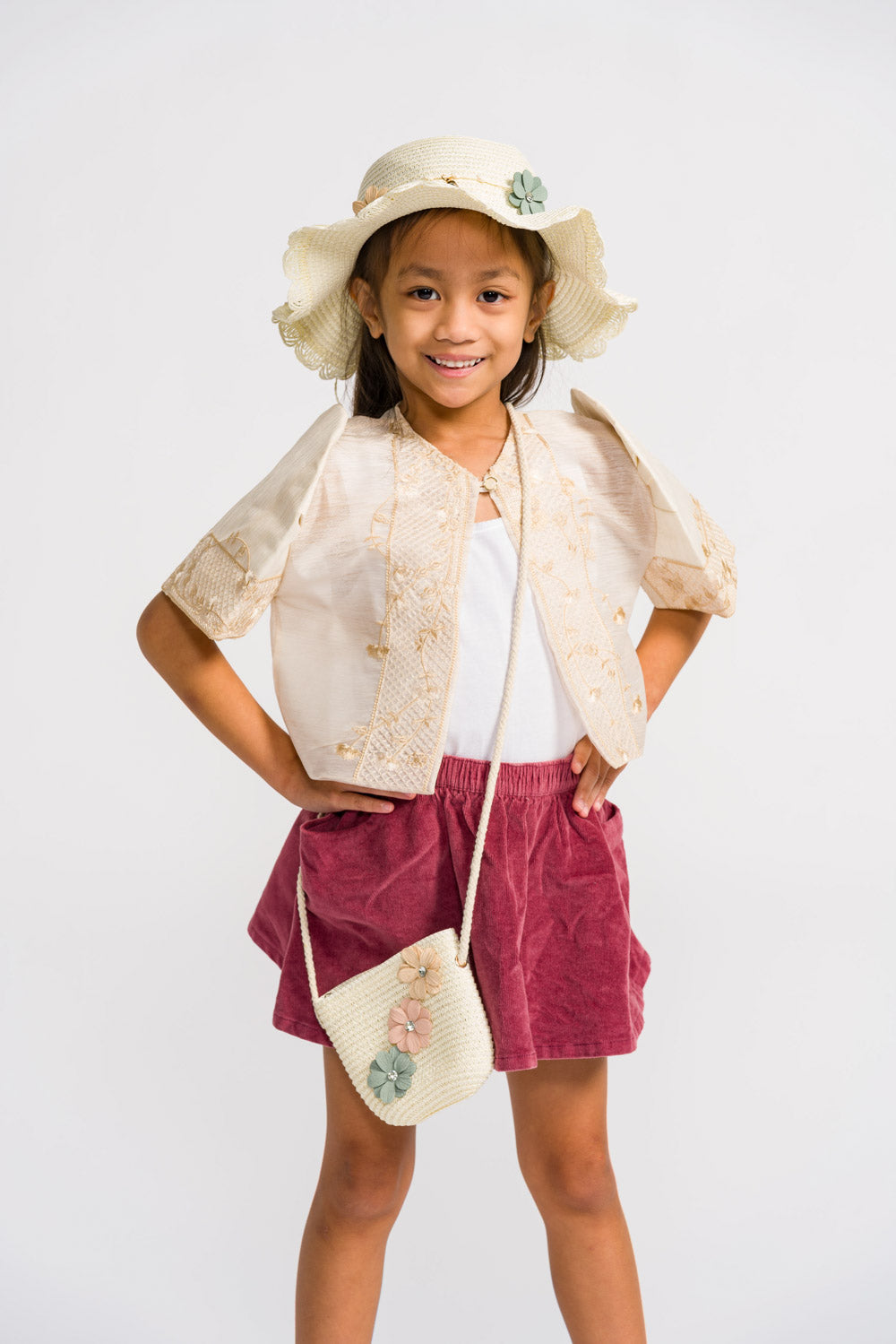 Young filipina girl wearing cream filipiniana bolero with butterfly sleeves and a casual outfit for filipino communion