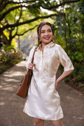 Model wearing the Amada Barong Dress in cream – Filipiniana shift dress with hand embroidery