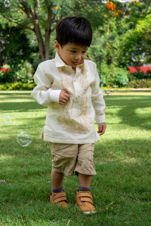 Filipino formal outfit for boys – Barong Tagalog paired with tan shorts