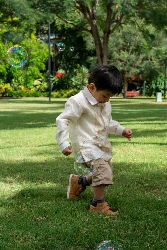 Filipino formal outfit for boys – Barong Tagalog paired with black trousers