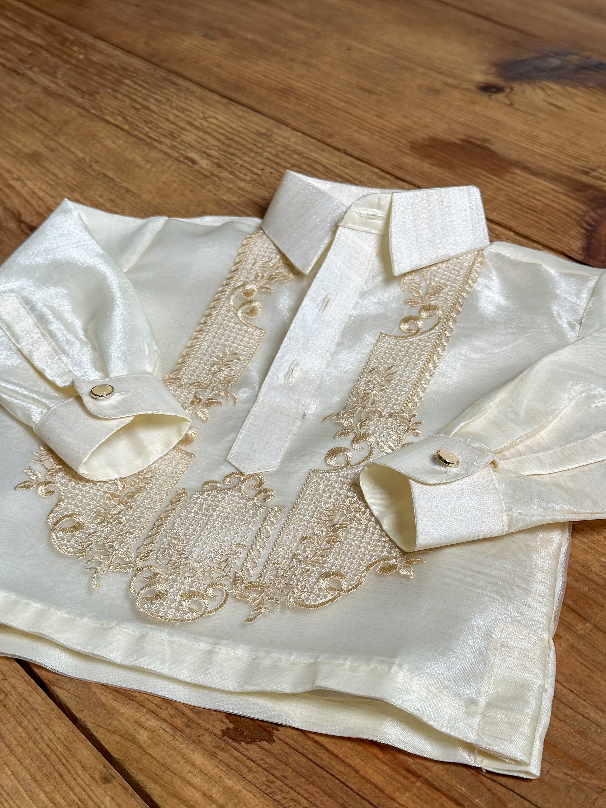 Close-up of embroidered detail on boys’ Barong Tagalog in piña-inspired cream organza