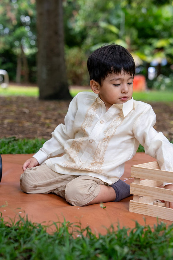 Child wearing Antonito Barong Tagalog in cream – traditional Filipino formalwear for boys