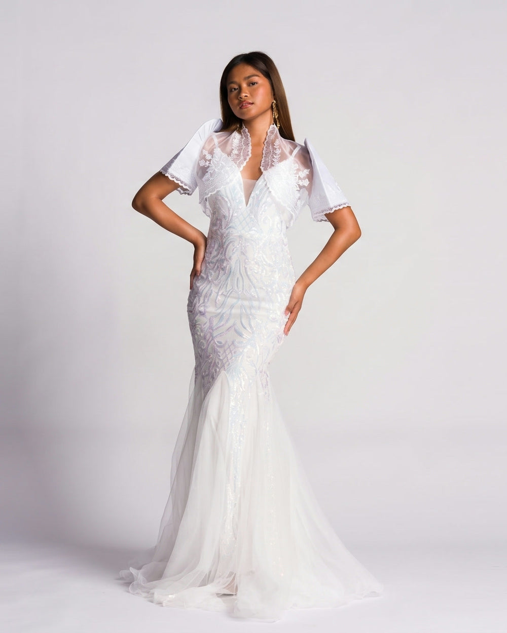 Bride in a white sequin and tulle Filipiniana gown with butterfly sleeve bolero