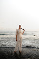 Modern Filipina wearing Barong Tagalog shirt in cream at the beach – cultural outfit inspiration