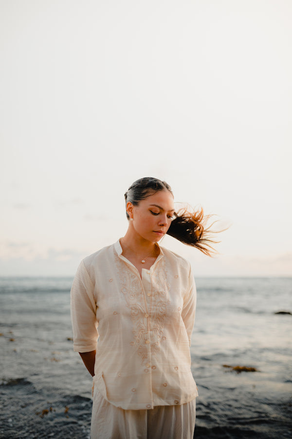 Modern Filipina wearing Barong Tagalog shirt in cream – cultural outfit inspiration