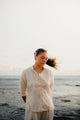 Modern Filipina wearing Barong Tagalog shirt in cream – cultural outfit inspiration